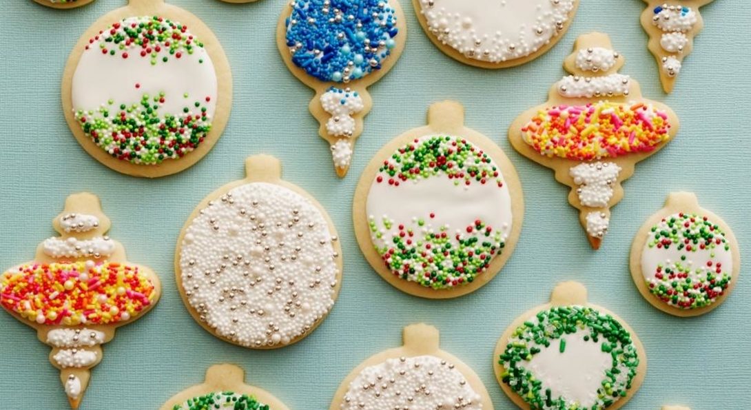 an array of cookies decorated as different Christmas onrmanents